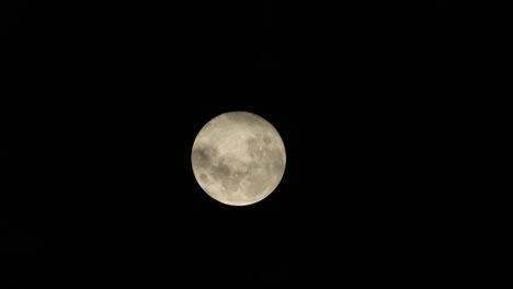 full moon with some clouds moving in front of it nighttime, maffra, gippsland, victoria, australia