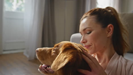 caring woman stroking doggy at carefree home morning closeup. girl caressing dog
