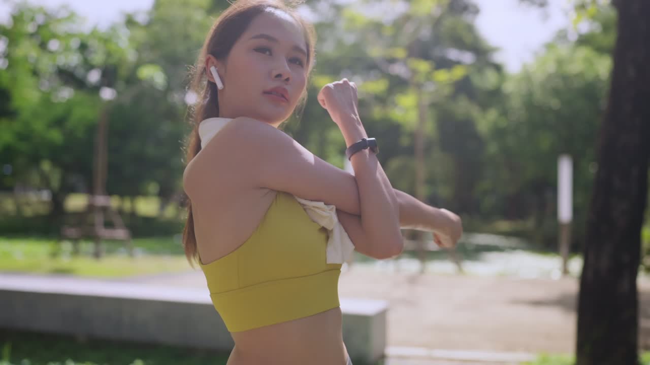 asian cheerful young adult Attractive and strong morning stretching before runing the park Sports concept. Healthy lifestyle Young fitness woman runner stretching before run at The public city park