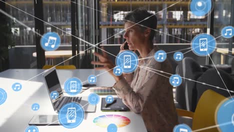 Animación-De-íconos-Conectados-Sobre-Una-Mujer-Birracial-Sentada-En-Una-Silla-Hablando-Por-Teléfono-Celular