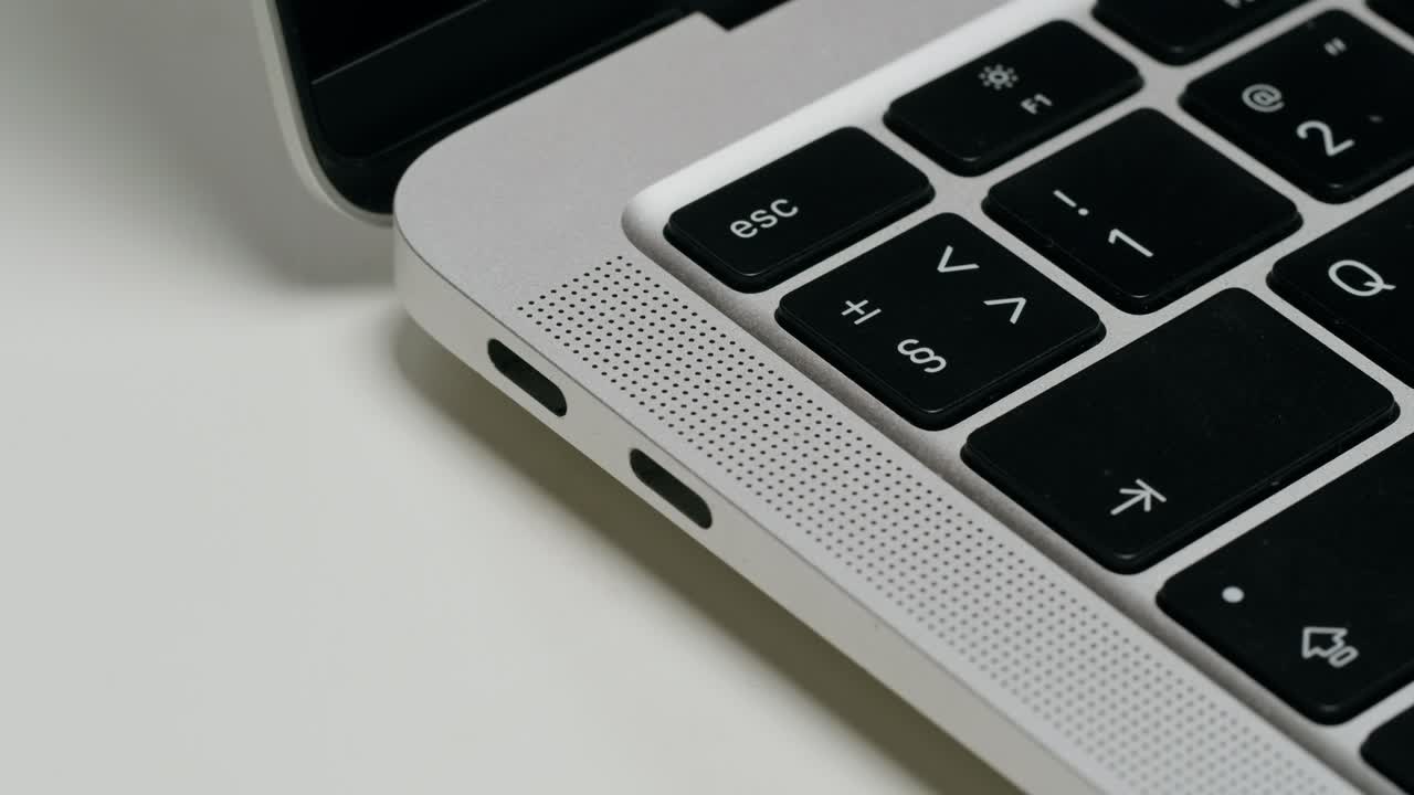 Close-up of a silver laptop keyboard and ports