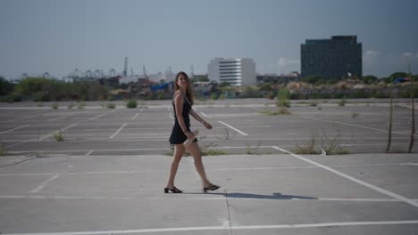 woman walking in an empty parking lot