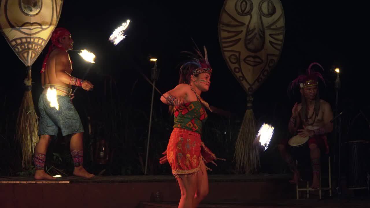Group of Fire Performers Juggling and Spinning Burning Poi Heads During Balinese African Rhythm Fire Dance Show at Night Bali Safari And Marine Park, Indonesia - slow motion
