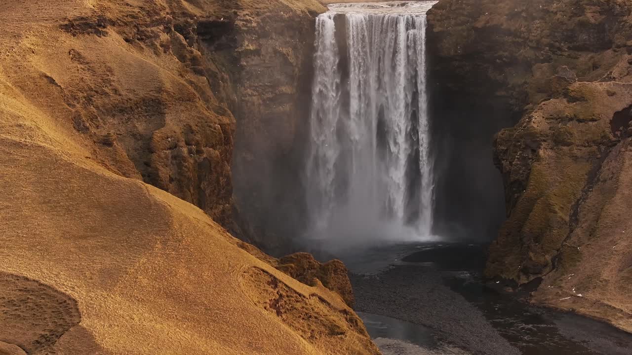 Skógafoss waterfall cascading down the Skógá River, Iceland, surrounded by rugged cliffs