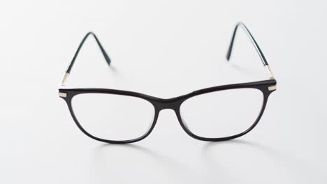 video of pair of glasses on white background with copy space