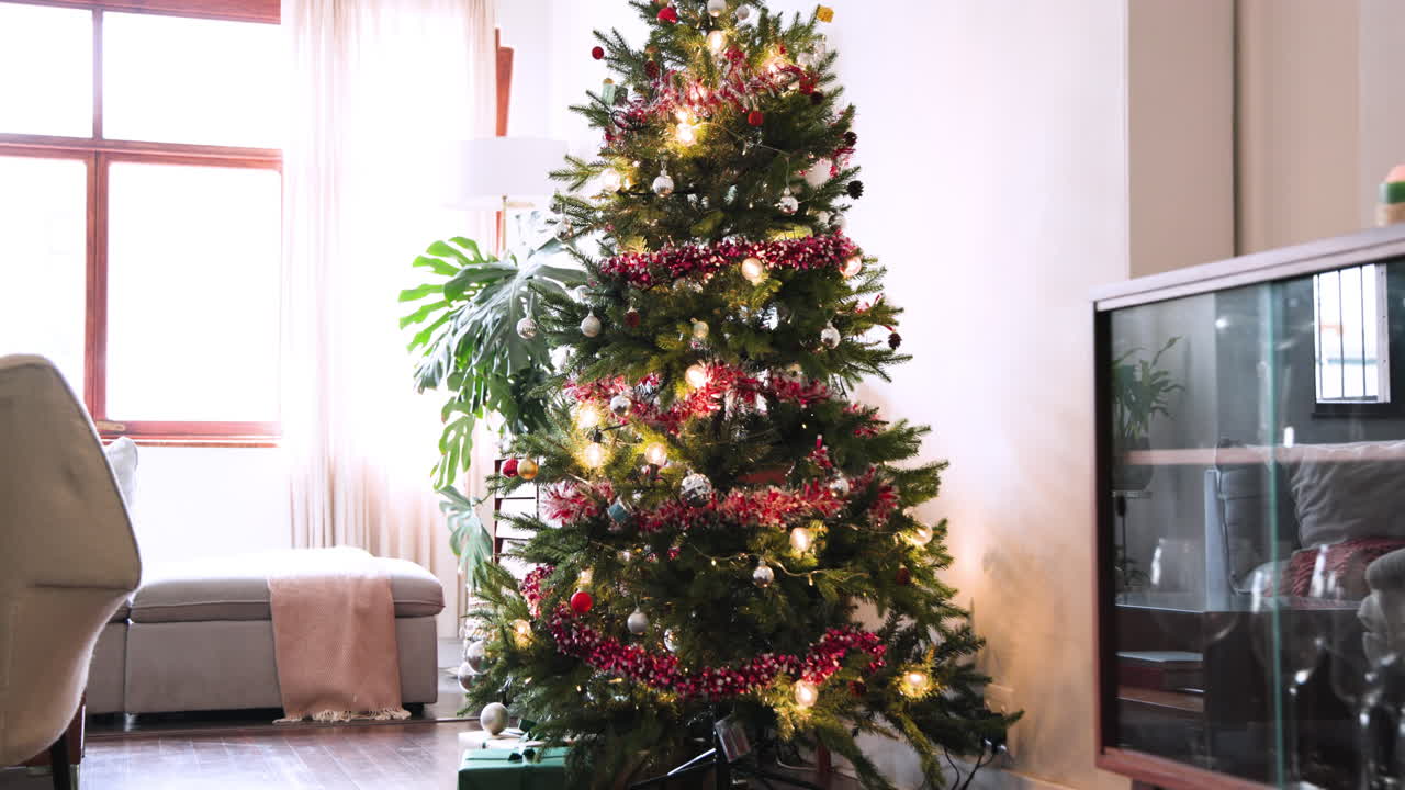 Festive Christmas tree with lights and ornaments in cozy living room, at home