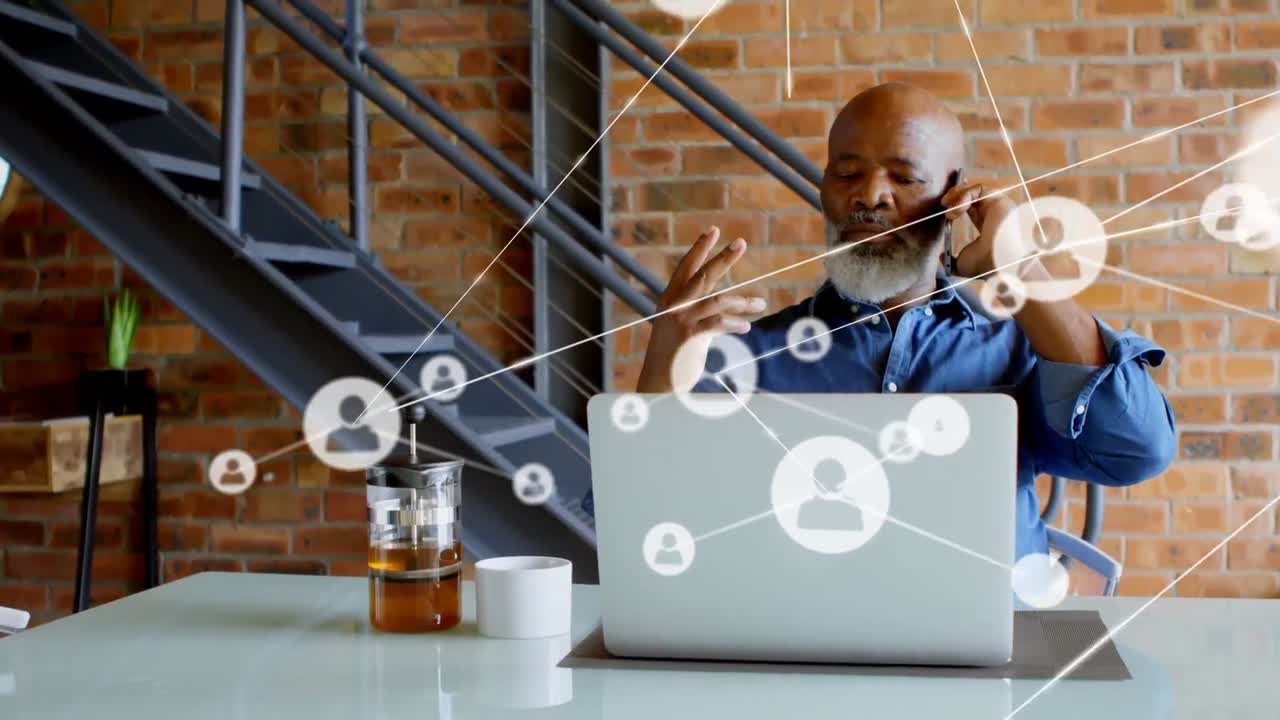 Animation of network of profile icons over african american man talking on smartphone at office