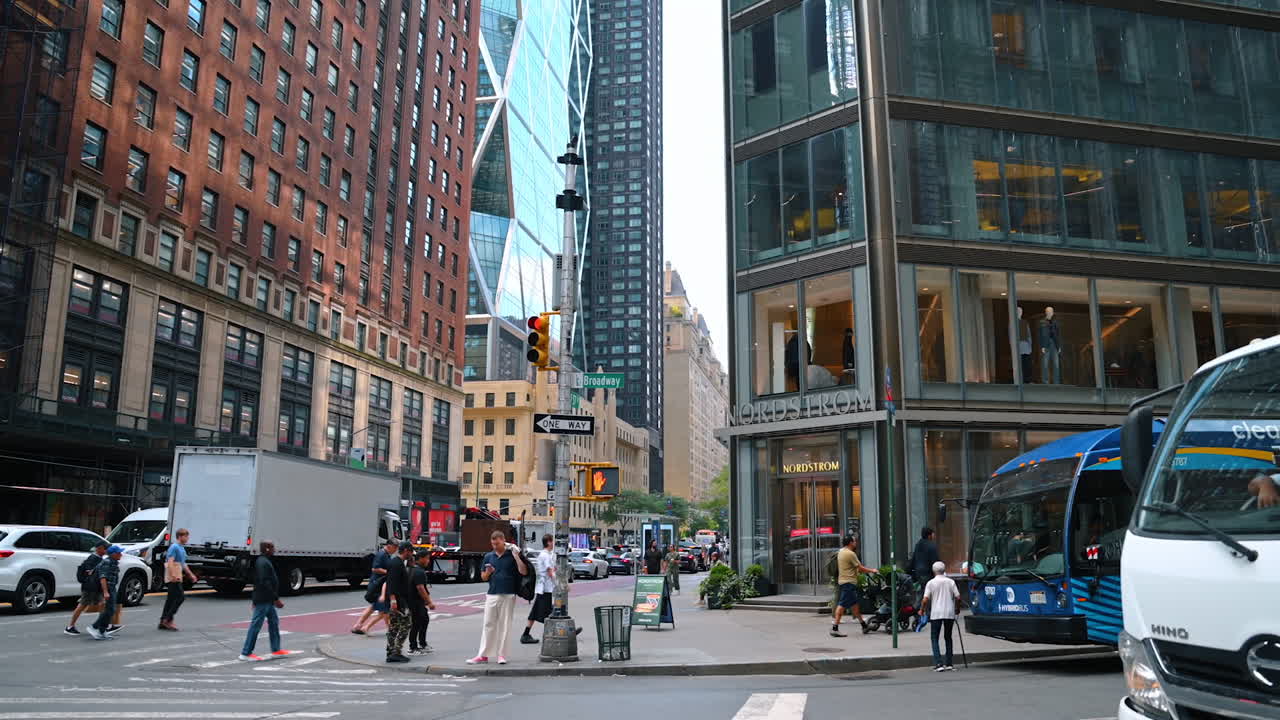 Broadway street sign with traffic and modern buildings
