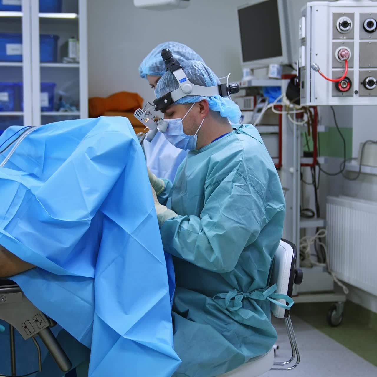 Vertical Screen: Doctor sits near the patient at operation. Focused medical professional performing otolaryngology surgery