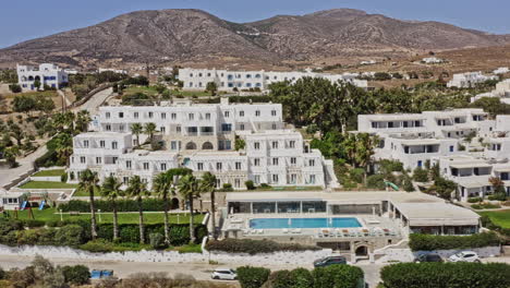 chrisi akti paros greece aerial v1 low level birds eye view drone fly around hillside beach resort capturing the beautiful summer season at the golden beach - september 2021