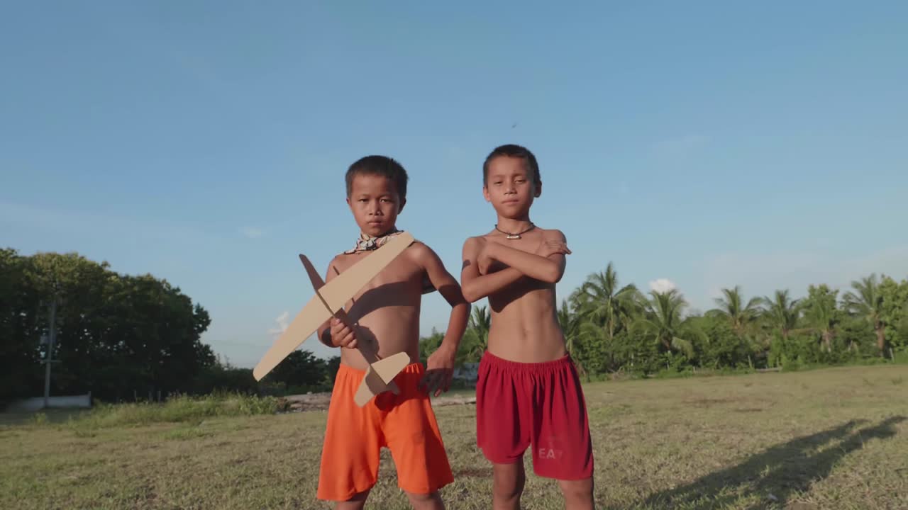 Two Boys Playing with Toy Planes
