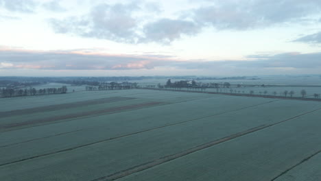 Beautiful-aerial-of-frozen-rural-Dutch-countryside-at-dawn