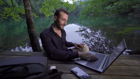 businessman working with his laptop in nature.