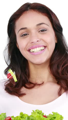 pretty smiling woman eating salad