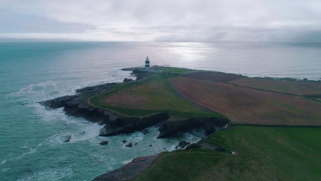 Lighthouse-on-a-rocky-shore-aerial