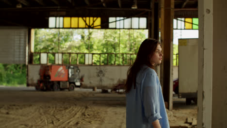 woman in abandoned industrial warehouse