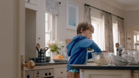 happy little boy eating left over cookie dough in kitchen enjoying delicious sweet taste licking fingers having fun on weekend