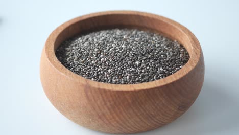 close up of chia seeds in wooden bowl