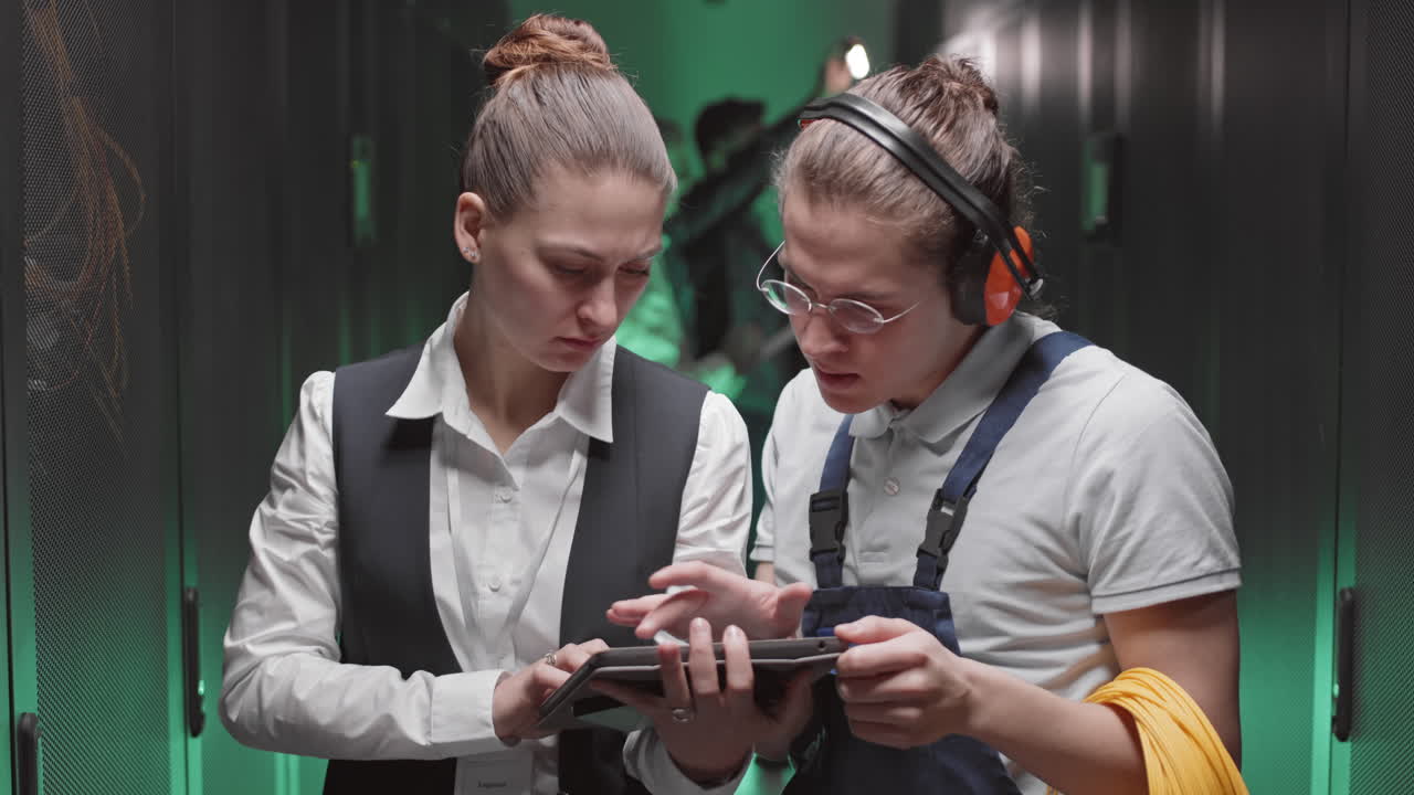 Data Center Technicians Collaborating on Tablet