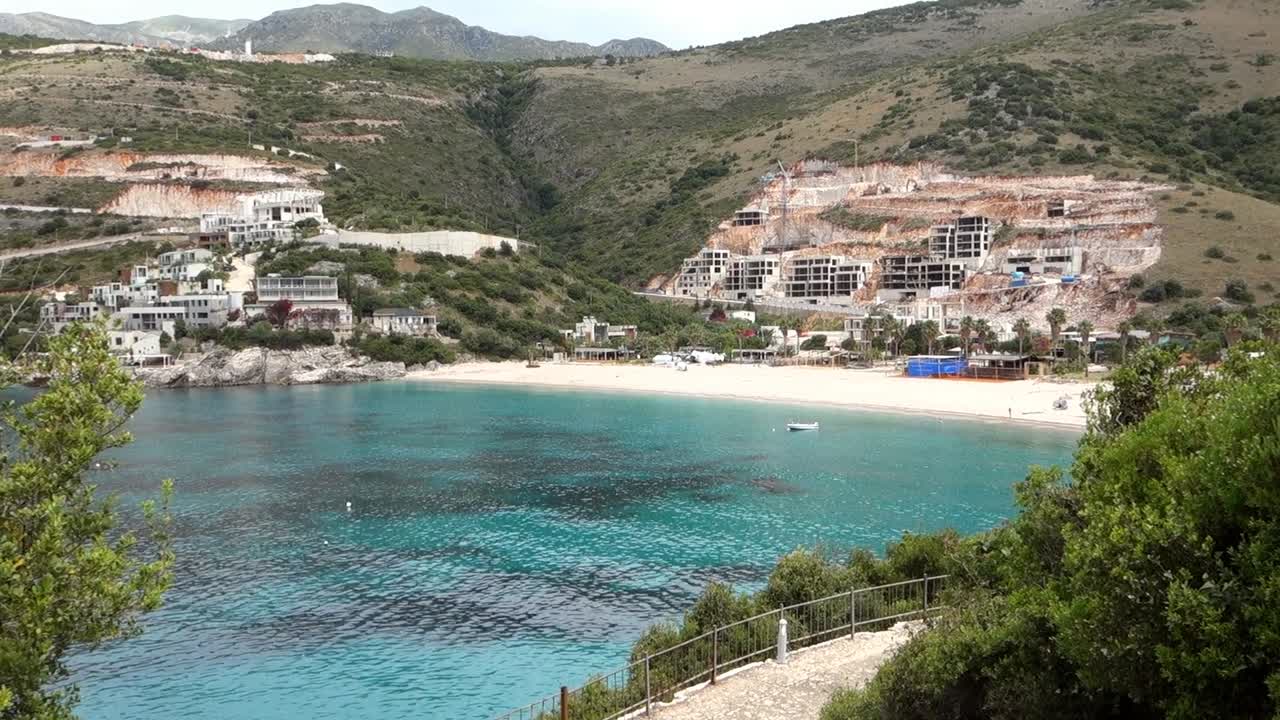 tilt up revealing Jale Beach in Himara, Albanian riviera. Resorts construction in background