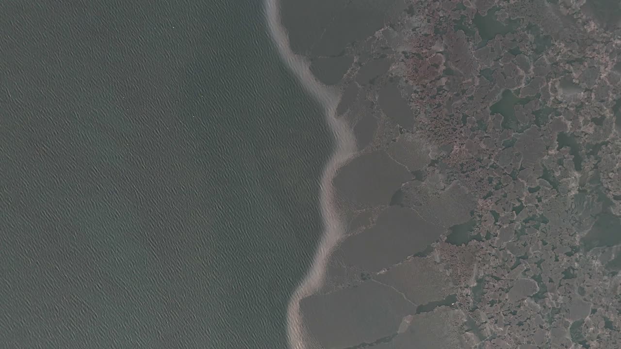 Aerial drone footage of frozen sea ice, highlighting dramatic ice formations and the effects of global warming