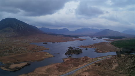 wide aerial orbit over connemara national park at twilight, featuring serene lakes and majestic mountains