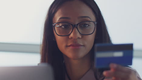 Businesswoman-Working-On-Laptop-At-Desk-In-Office-Making-Online-Payment-With-Credit-Card