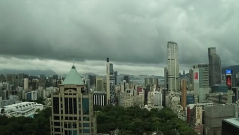 hong kong city over looking kowloon park's time lapse from high above,clouds run over the bay and park.