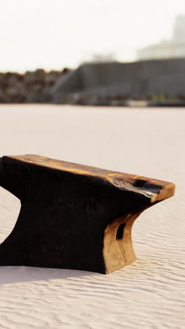 a rusty anvil on a sandy beach