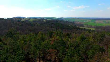 Lush-Spring-Landscape-With-Wooded-Hills---Aerial-Drone-Shot