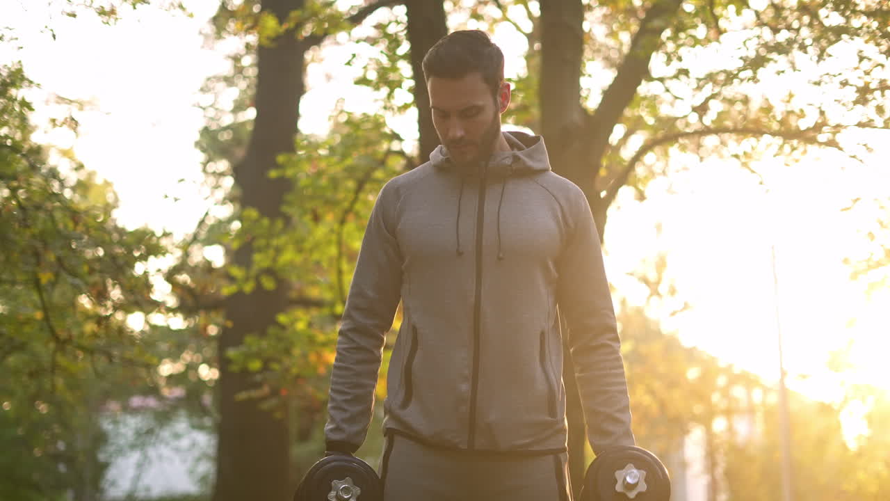 Man exercising with dumbbells outdoors
