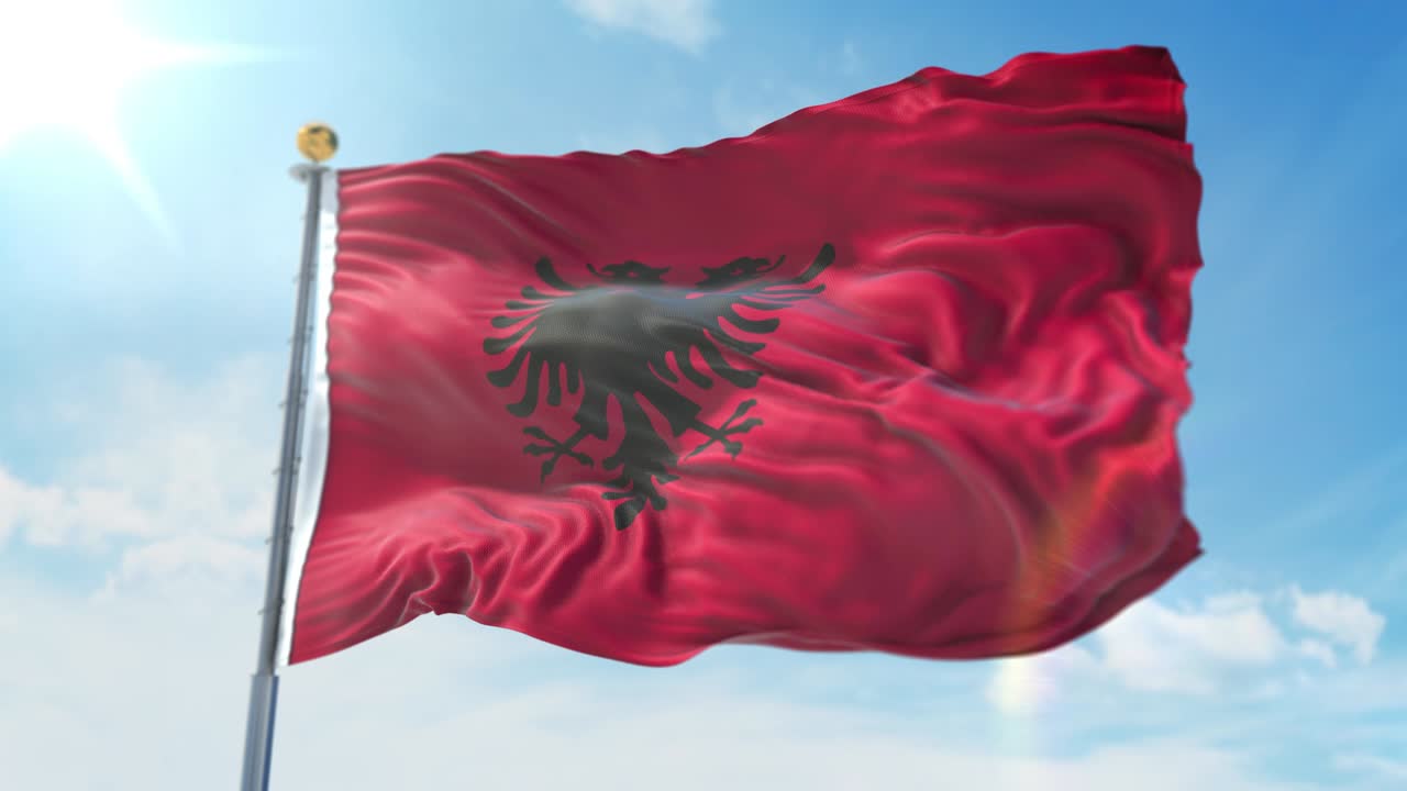 bandera de albania ondeando en el viento contra el cielo azul profundo. tema nacional, concepto internacional. 3d render ciclo sin costuras 4k