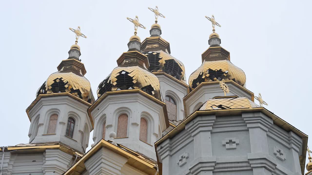 The golden domes of the Holy Myrrh-Bearing Women Church in Kharkiv show shrapnel damage, evidence of the shelling of Ukraine's cultural sites and civilian areas during the ongoing conflict