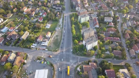 peaceful aerial drone flight above country road and buildings, forward