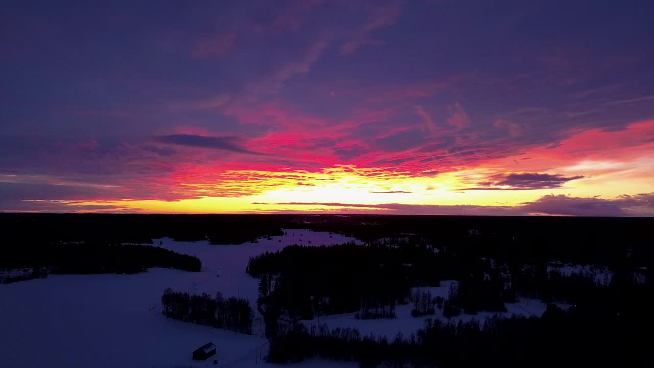 AERIAL of an vibrant and absolutely fantastic golden hour sky with beautiful colors, golden yellow pink purple blue