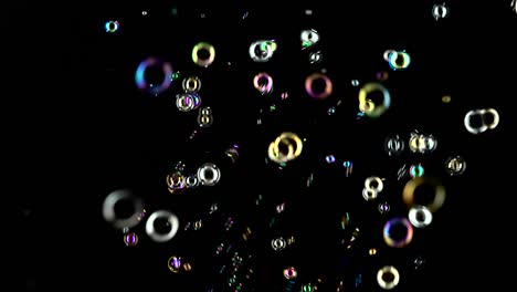 rainbow soap bubbles fly black background rainbow soap bubbles fly in the air and burst black backround
