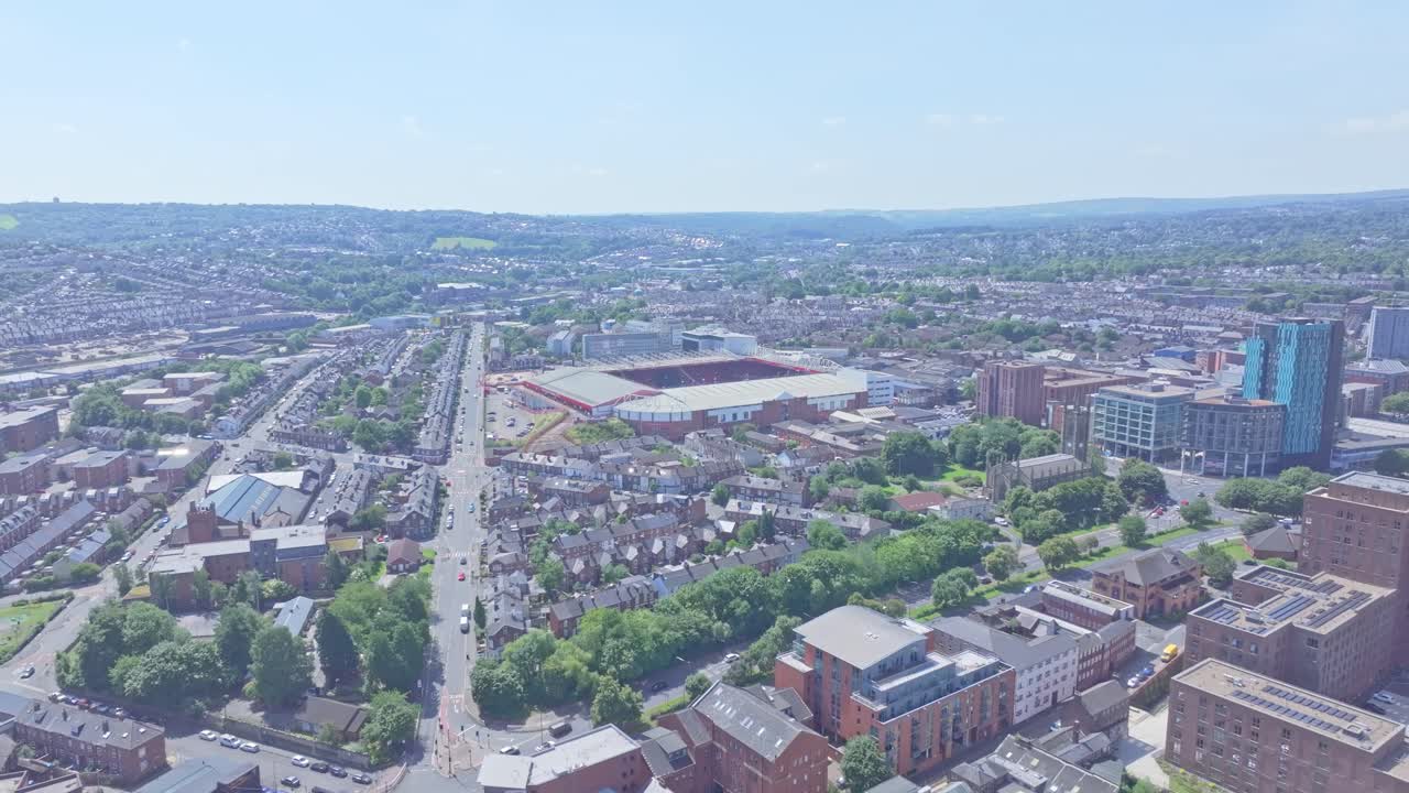 An aerial view of a clear day showcases the city’s blend of residential and commercial architecture, creating a vibrant and organized community with buildings, roads, and greenery.