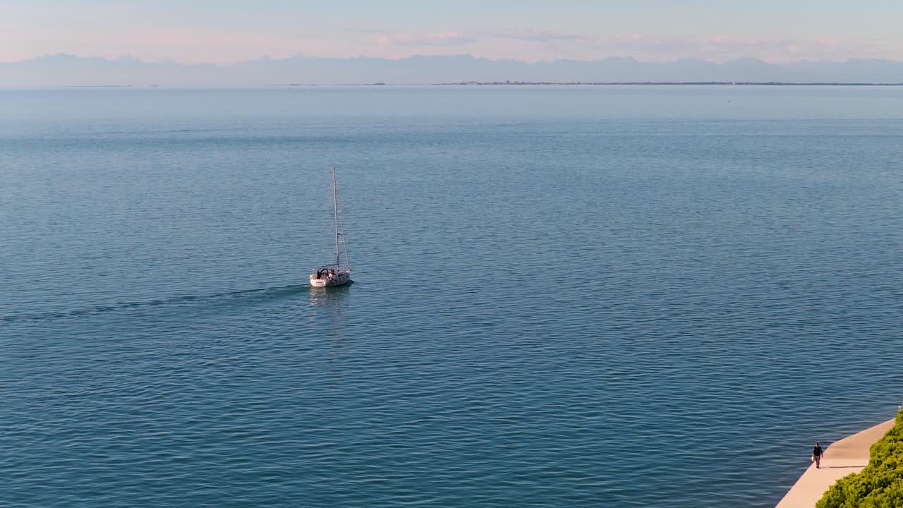 Aerial of boat in Adriatic Sea heading to Piran harbor, Slovenia