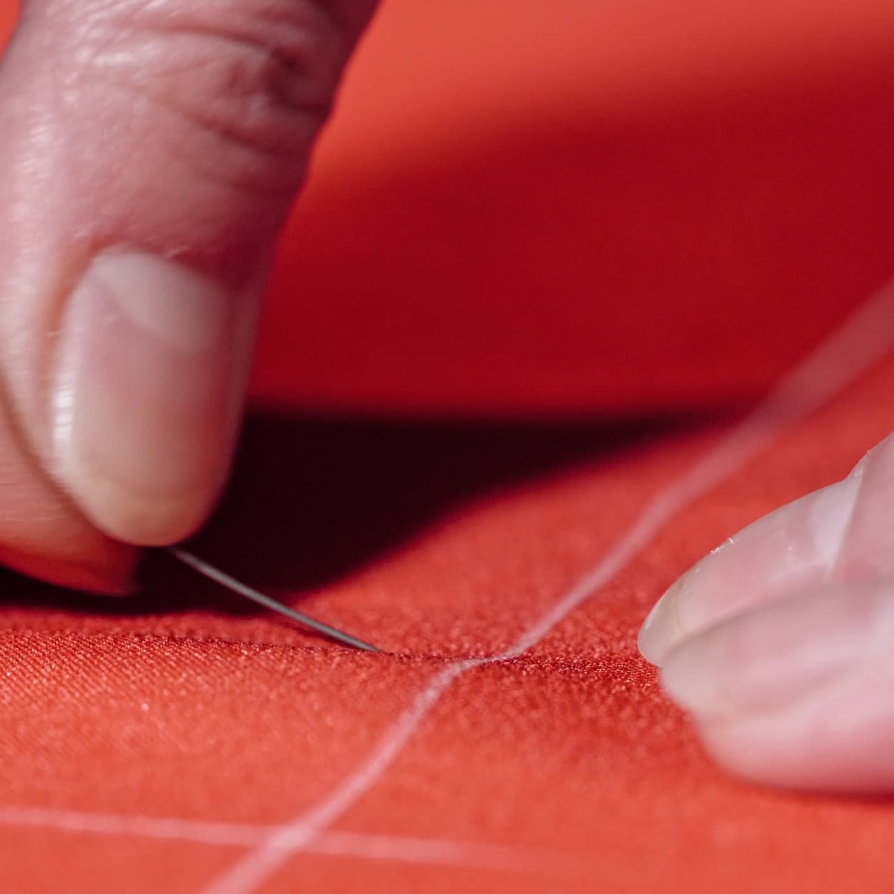 Seamstress working at table in atelier
