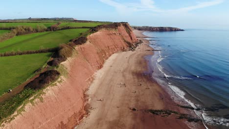 aerial along orcombe cliff coastline on sunny day