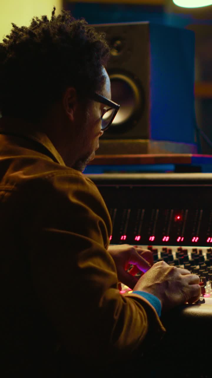 Man Operating Sound Mixing Console in a Recording Studio