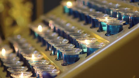close-up of multiple candles in church