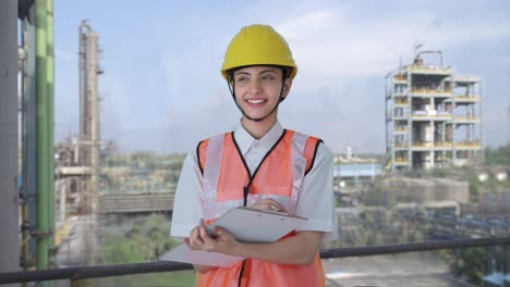 happy indian female architect taking notes in building