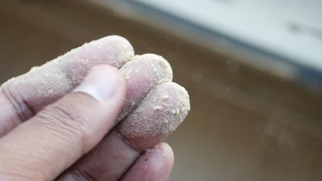 wood dust on fingers