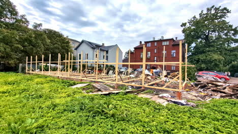 view of broken wooden house left over with structure at a neighborhood during daytime