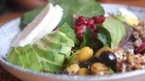 ensalada saludable con quinoa, aguacate, queso y granada