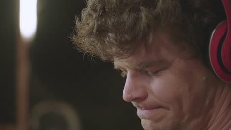 close up of a man bobbing his head while listening to music