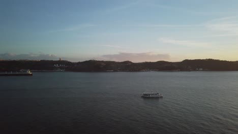 ferry boat passing by the tagus river in lisbon, portugal