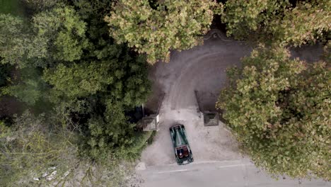 classic green colored convertible car entering a villa gate in the south of france, aerial looking down shot