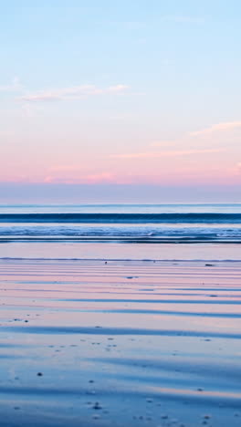 pastel sunrise or sunset over a calm ocean beach